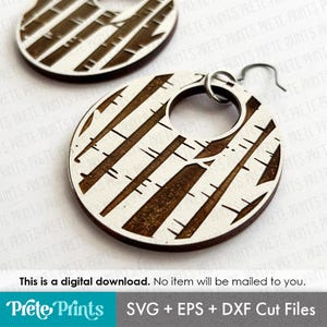 May include: Wooden earrings with a birch tree design. The earrings are round with a cutout circle and a silver hook. The design features vertical lines in a brown color against a white background. The text at the bottom says "This is a digital download."