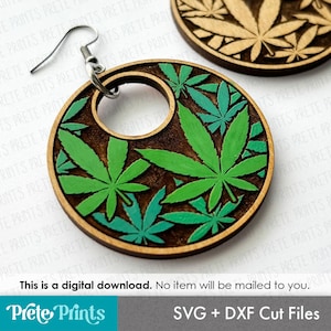 May include: Wooden earrings with a circular design featuring green and teal cannabis leaves on a brown background. The earrings have a silver hook and are digitally designed. The text "Prete Prints" and "SVG + DXF Cut Files" are also visible.