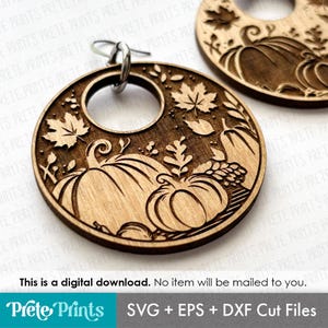 May include: Laser-cut wooden earrings with a seasonal autumn theme. The circular earrings feature pumpkins, leaves, and a central hole. The text "Prete Prints" and "SVG + EPS + DXF Cut Files" are at the bottom. The text "This is a digital download. No item will be mailed to you." is also present.
