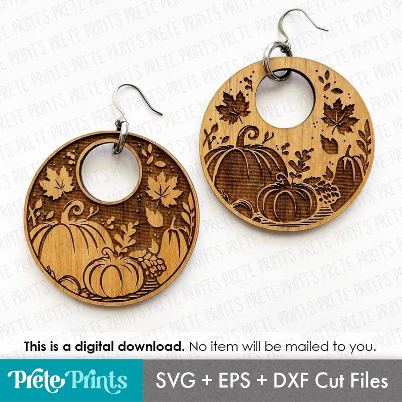 May include: Wooden round earrings with a laser-cut fall harvest design. Each earring features pumpkins, leaves, and a central circular cutout. The earrings are suspended from silver-colored ear wires. The image also includes the text: "This is a digital download. No item will be mailed to you."