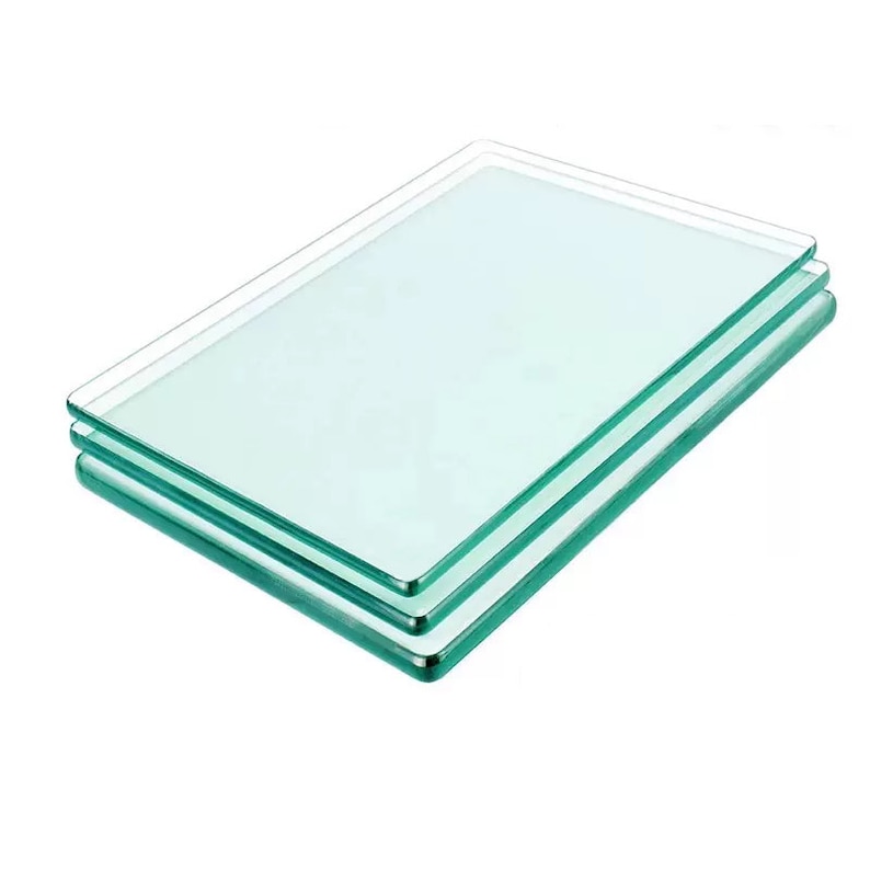 May include: Three clear glass cutting boards stacked on top of each other. The boards have a slightly green tint and rounded edges.