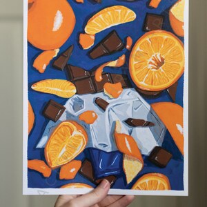 May include: A painting depicting orange segments and pieces of chocolate on a blue background. The orange segments are arranged in a random pattern, and the chocolate pieces are scattered around them. The painting is executed in a realistic style.