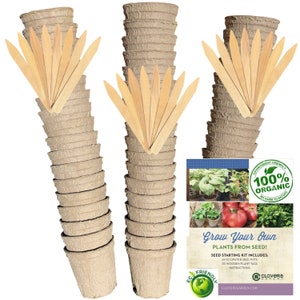 May include: A set of 60 biodegradable seed starting pots, 30 wooden plant tags, and instructions for growing plants from seed. The pots are stacked in two columns, and the tags are fanned out in front of the pots. The packaging includes the text "Grow Your Own Plants from Seed!" and "Environment Friendly 100% Organic No Harm to Nature".