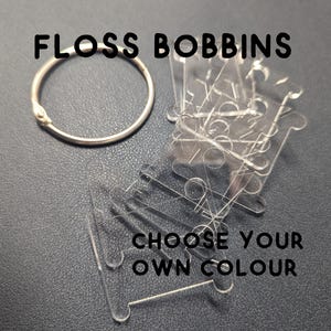May include: A set of clear plastic floss bobbins with a silver ring. The bobbins are stacked on top of each other and the text "Choose your own colour" is printed below them.