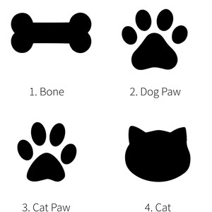 May include: Black and white illustrations of a bone, a dog paw print, a cat paw print, and a cat head.