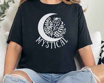 May include: A black t-shirt with a white crescent moon and floral design. The text "MYSTICAL" is printed below the design.
