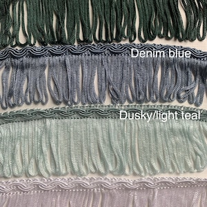May include: Four different colours of fringe trim, from top to bottom: dark green, denim blue, dusky/light teal, and light lavender.
