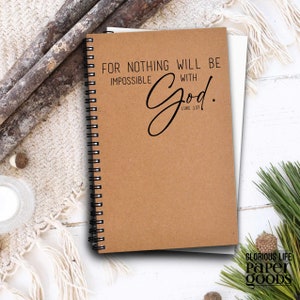 May include: A brown spiral bound notebook with the text "For nothing will be impossible with God. Luke 1:37" printed on the front cover.