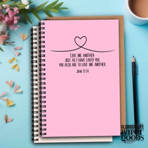 May include: Pink spiral notebook with a black heart and the quote "Love one another: Just as I have loved you, you also are to love one another. John 13:34".