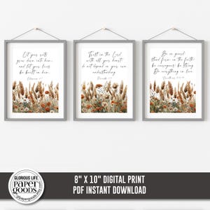 May include: Three framed 8x10 inch digital prints with inspirational quotes and floral watercolor art. Each print features a different quote in black script, set against a backdrop of dried grasses and flowers in shades of brown, beige, and orange.