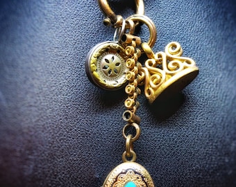 Antique collection of Victorian pendants consiting of an enamel gold filled locket, a gold filled monogramed fob and a sterling silver charm