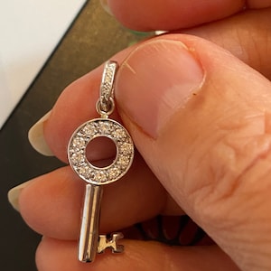 14kt white gold diamond circularKey to your heart charm pendant pavé set with 13 full cut brilliant diamonds total dia weight .55ct