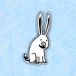 May include: A white rabbit with long ears and a black nose is drawn in a cartoon style. The rabbit is smiling and has a happy expression. The background is a light blue with a swirling pattern.