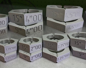 May include: A set of 10 gray metal rings with different sizes and angles. The rings are labeled with measurements in inches and degrees. The rings are used for woodworking and other crafts.