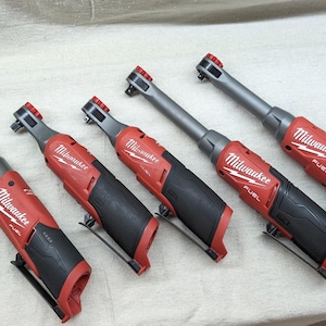 Puede incluir: Cinco llaves de trinquete Milwaukee FUEL de 1/4 de pulgada con mangos rojos y negros. Las llaves están dispuestas en una fila de la más grande a la más pequeña.