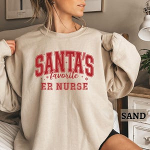 Sweat-shirt de Noël, pull d'infirmière des urgences, cadeau de Noël pour infirmière des urgences, col rond de Noël préféré du père Noël, cadeau d'appréciation de l'infirmière des urgences pour elle