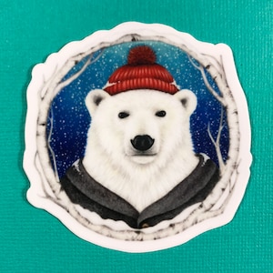 May include: A white polar bear wearing a red knit hat with a white pom pom, a gray jacket, and a white scarf. The bear is set against a blue background with white snowflakes and birch branches.