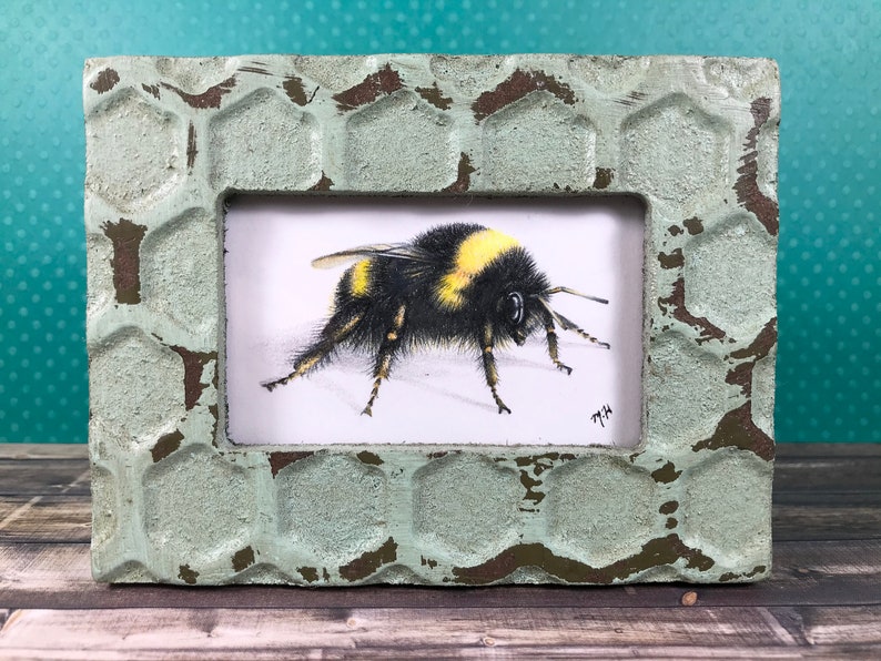 Bee drawing in a honeycomb frame