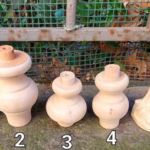 May include: Six wooden furniture feet or finials in various styles. The feet are unfinished and ready to be stained or painted. They are numbered 1 through 6.