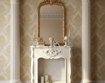 May include: A white fireplace with a gold-framed mirror, flanked by two white columns. The mirror reflects the room, and candles and decorative items sit on the mantel. The wallpaper has a gold pattern, and a red and brown rug is on the floor.