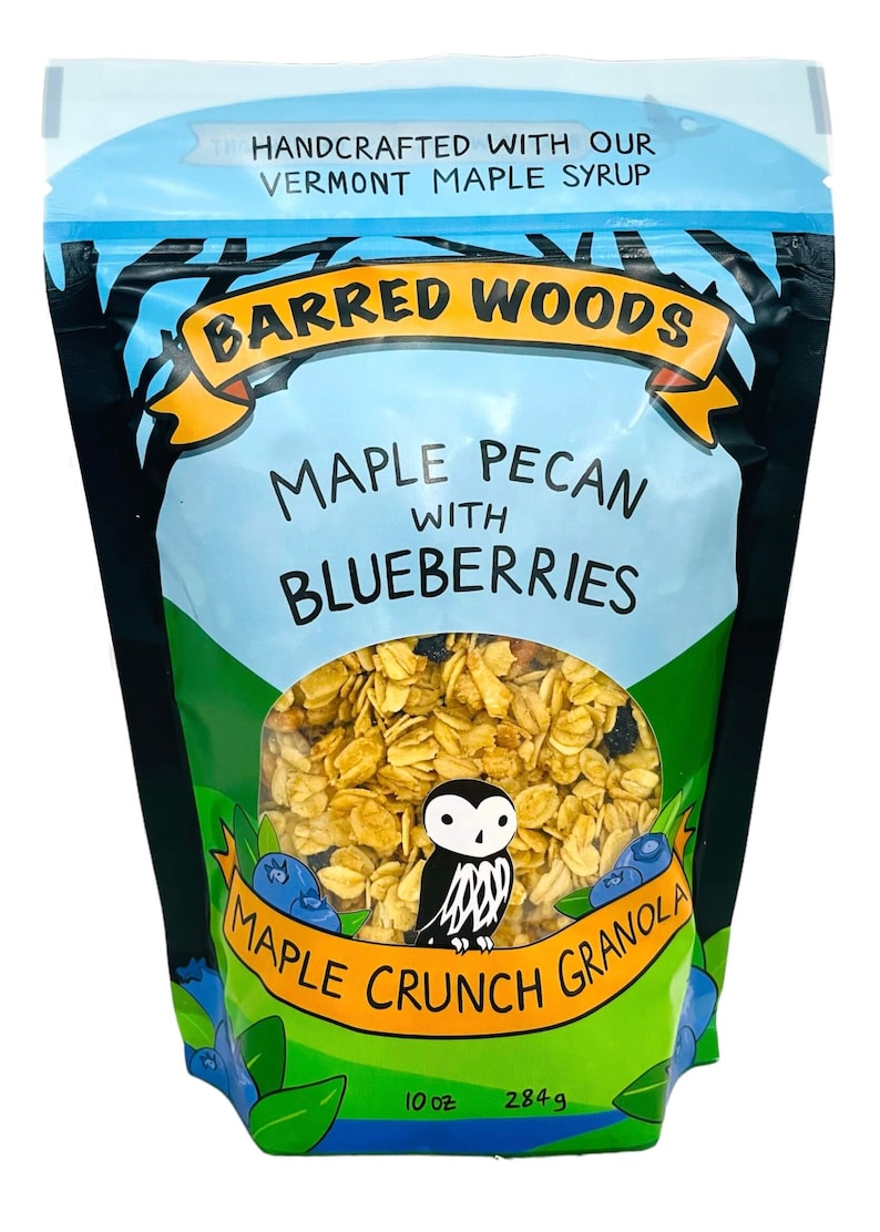 Puede incluir: Una bolsa azul y verde de granola Barred Woods Maple Pecan con ar&aacute;ndanos y jarabe de arce. La bolsa presenta una ilustraci&oacute;n de un b&uacute;ho y ar&aacute;ndanos. La bolsa es de 10 oz (284 g).
