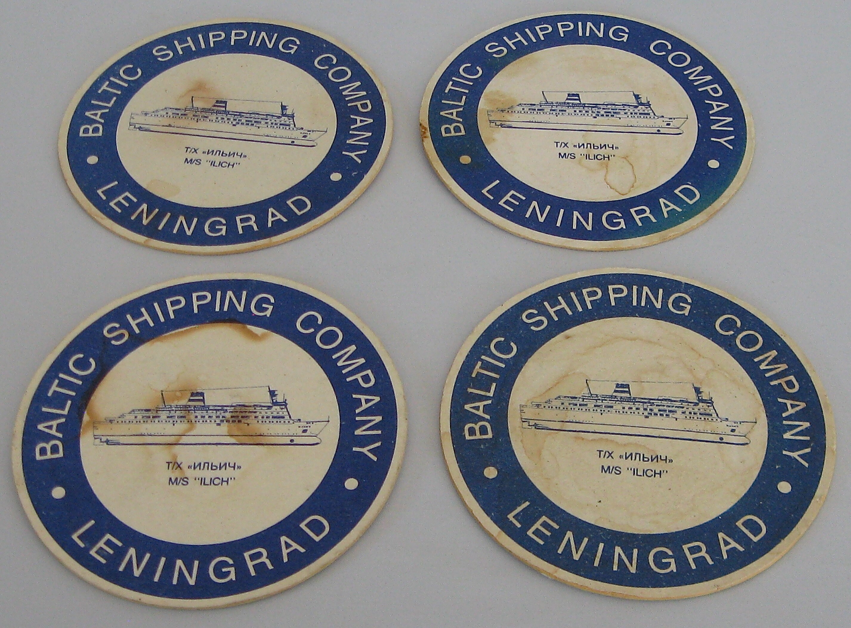 Four cardboard coasters from Baltic shipping company Etsy