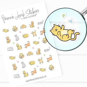 May include: Sheet of Frannie Lamb Stickers featuring hand-illustrated cat designs in various poses and colors, including yellow, gray, and orange. Some cats are in boxes. The sheet includes the website address www.frannielambstickers.com.