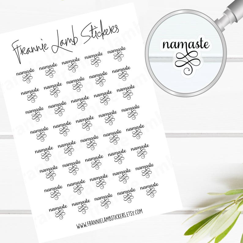 May include: A sheet of white sticker paper with 30 black and white stickers that say "namaste" with a decorative swirl design. The stickers are arranged in rows of five. The text "Freannie Lamb Stickers" is at the top of the sheet. The text "WWW.FRANNIELAMBSTICKERS.ETSY.COM" is at the bottom of the sheet.