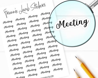 May include: A sheet of white sticker paper with the text "Freannie Lamb Stickers" at the top. The sheet is filled with black cursive text that says "Meeting" repeated 36 times. A magnifying glass is positioned over the sheet, highlighting the word "Meeting".