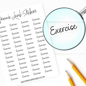 May include: A sheet of white paper with the text "Freanie Lamb Stickers" at the top. The sheet is filled with 36 black and white stickers that say "Exercise" in a handwritten font. A magnifying glass is in the upper right corner of the image, showing a close-up of one of the stickers.