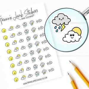 May include: A sheet of weather-themed stickers featuring various cloud designs with smiling faces. The stickers include clouds with sunshine, rain, lightning, and wind. The text "Frannie Lamb Stickers" and "Hand Illustrated" is printed at the top of the sheet.