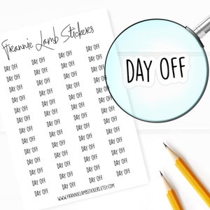 May include: A sheet of white paper with the text "Freannie Lamb Stickers" at the top. The paper is filled with black text that reads "DAY OFF" repeated many times. A magnifying glass is focused on one of the "DAY OFF" stickers.