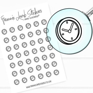 May include: Sheet of black and white clock stickers with the text "Frannie Lamb Stickers Hand Illustrated" and the website address "www.frannielambstickers.etsy.com". A magnifying glass is focused on one of the clock stickers.