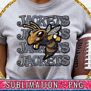 May include: Sublimation design featuring a cartoon bee with gold and black accents, surrounded by the word "Jackets" in a glittery font. The design is on a grey t-shirt.