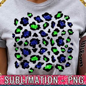 May include: Sublimation design featuring a leopard print pattern with blue and green glitter accents. The design is on a grey t-shirt.