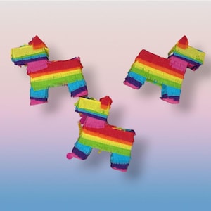 May include: Three colorful dog-shaped piñatas. Each piñata is crafted with vibrant rainbow-colored fringed paper, featuring red, orange, yellow, green, blue, and purple hues. The piñatas are set against a gradient background.