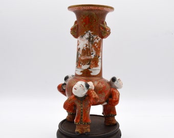 Three Japanese Figures Lifting Kutani Spill Vase