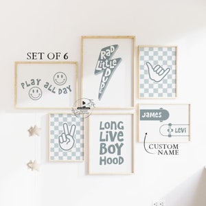 May include: Set of six printable wall art prints in a light gray color scheme. The prints feature various designs including a skateboard, a peace sign, a smiley face, a lightning bolt, and a checkered pattern. The text on the prints includes "Play All Day", "Rad Little Dude", "Long Live Boy Hood", and "Custom Name".
