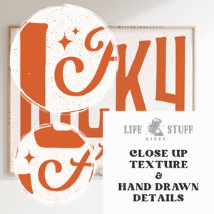 May include: A framed print with the words "LIFE KINDA STUFF" in orange, stylized lettering. The background is white with a speckled texture. The print also includes the text "CLOSE UP TEXTURE & HAND DRAWN DETAILS".