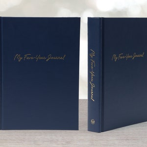 May include: A navy blue journal with gold lettering that reads "My Five-Year Journal".