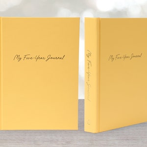 May include: Two yellow hardcover journals with the text "My Five-Year Journal" on the front cover.