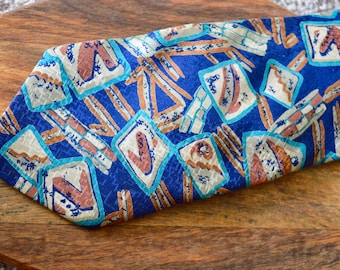 May include: A blue silk tie with a geometric pattern in shades of brown, blue, and white.