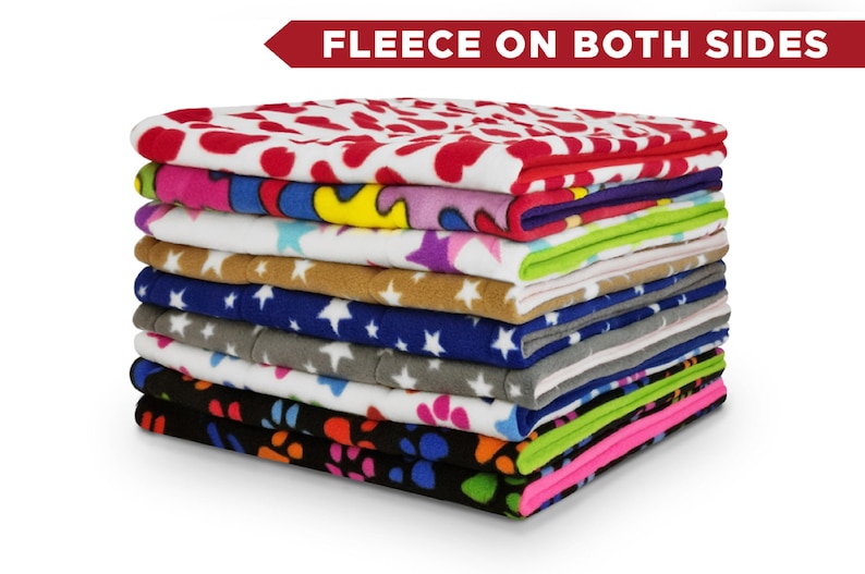 May include: A stack of 10 colourful fleece blankets with various patterns, including hearts, stars, and paw prints. The text "Fleece on Both Sides" is displayed above the stack.