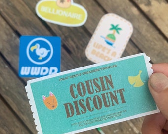 May include: A teal blue coupon with the text "Jolly Redd's Treasure Trawler Cousin Discount" in brown text. The coupon has a small illustration of a fox in the top left corner and a bell in the top right corner. The text "Limit one (1) piece of art per customer per day All sales final | No refunds" is printed in white text at the bottom of the coupon.