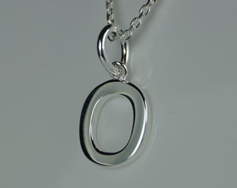 May include: A silver-colored pendant necklace featuring the letter "O". The pendant is a polished, open-letter design, suspended from a delicate chain. The necklace is displayed against a soft, neutral background. The text "LoveYourJewellery" is in the top left corner.