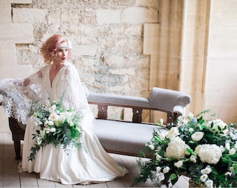 Unique Ivory crepe wedding gown with satin trim and Lace feather Cape