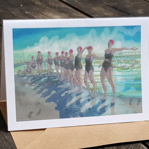 Tarjeta de felicitación de Nancy Farmer: “A Lovely Line of Duckies”: natación sincronizada al aire libre, agua fría, Clevedon Marine Lake.