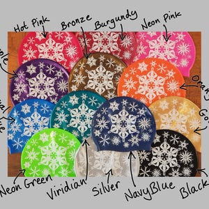 May include: Twelve silicone swim caps in various colours with a snowflake pattern. The colours include purple, royal blue, neon green, viridian, silver, navy blue, black, orange gold, bronze, burgundy, hot pink, and neon pink.