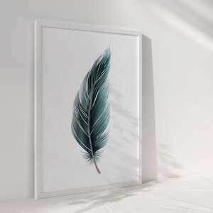 May include: A framed print of a single teal blue feather on a white background.