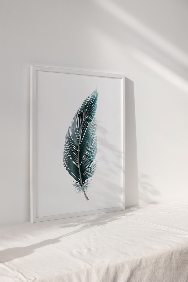 May include: A framed print of a single teal blue feather on a white background.